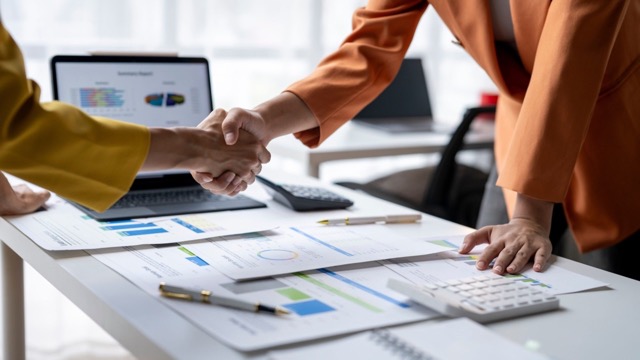 SVMA advisors shaking hands with a business owner